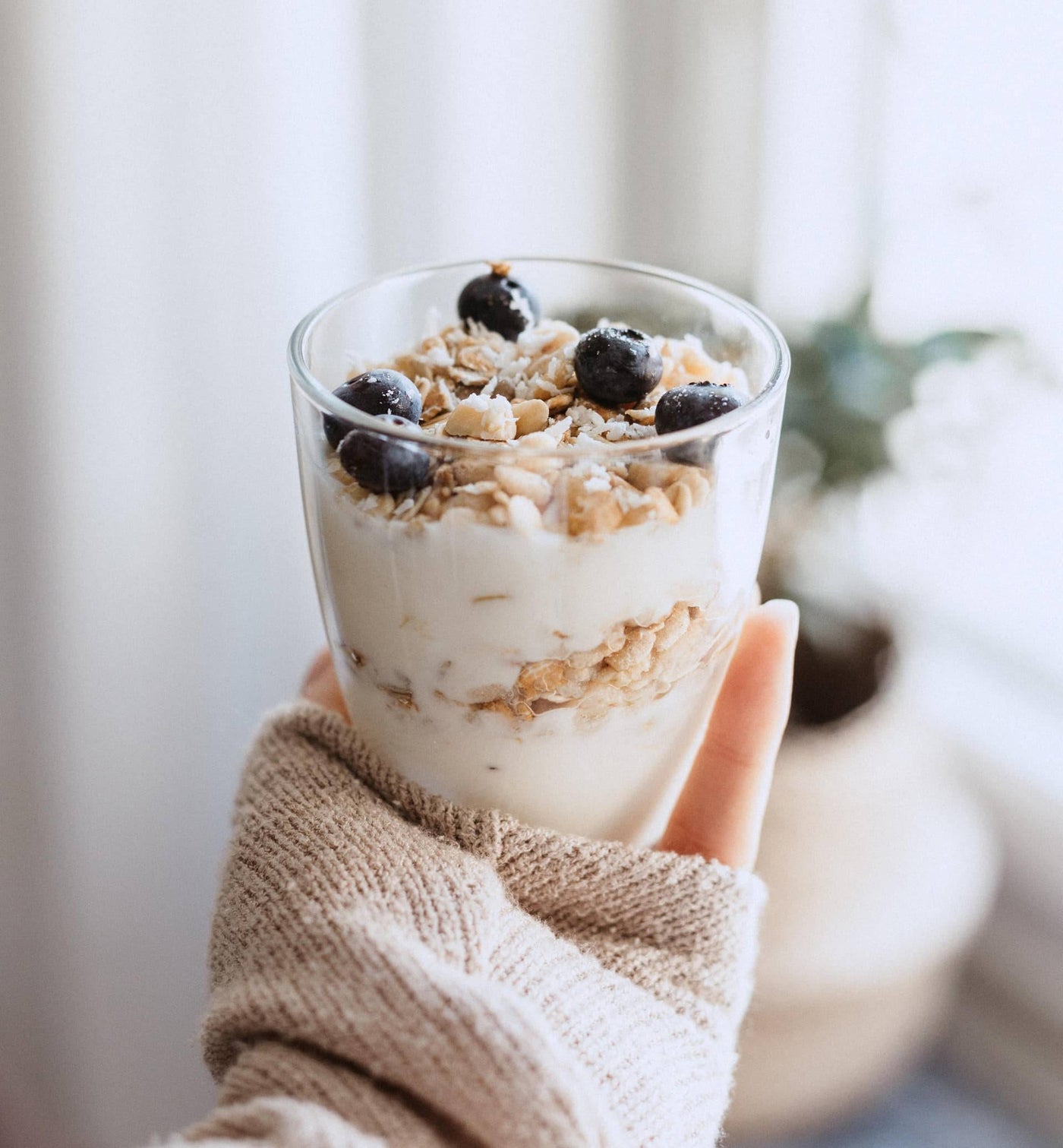 Gesunder Snack: ein Glas voll mit Joghurt, Nüssen und Beeren